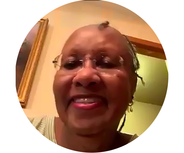 Headshot of Evelyn Dungey on Zoom. She has dark skin coloring and a big smile, and her hair is tightly braided.