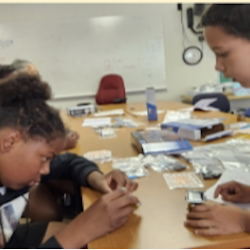 Photo of a child working with a mentor on a Sill Byrd Solar robot