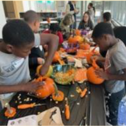 Greer students carving pumpkins